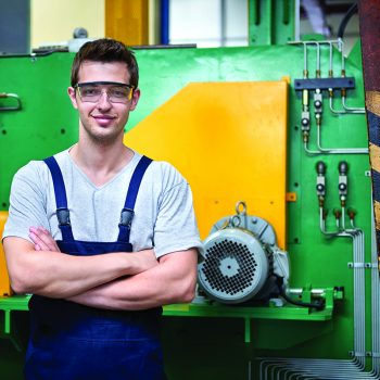 young apprentice in front of machinary